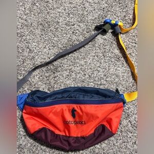 Cotopaxi Colorful Belt Bag in orange , Blue, and Yellow